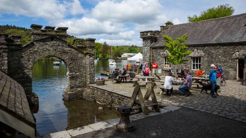 Visitors outside the Boathouse cafe in spring at Fell Foot, Cumbria